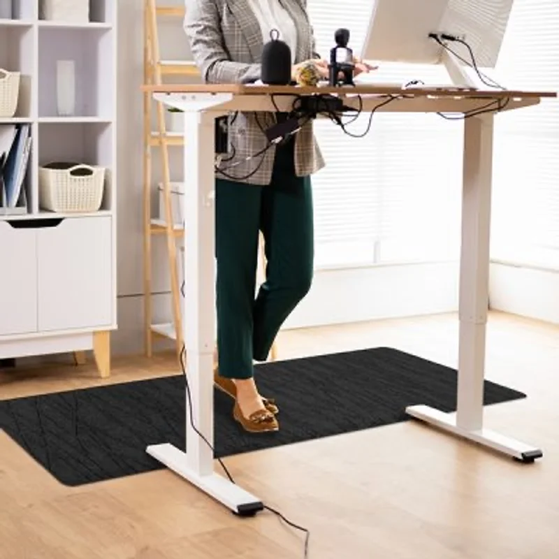 Anti-fatigue mat under a standing workstation