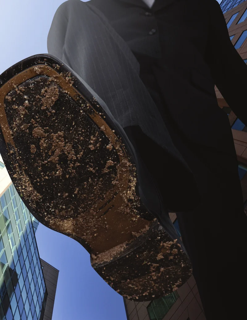Dirty shoe sole about to step, seen from below